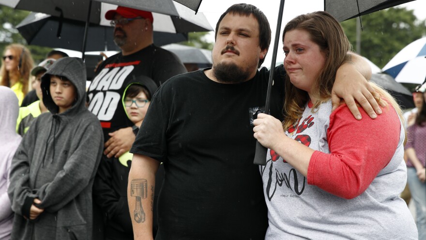 People gather at a vigil for victims of a mass shooting at a municipal building in Virginia Beach, Va.