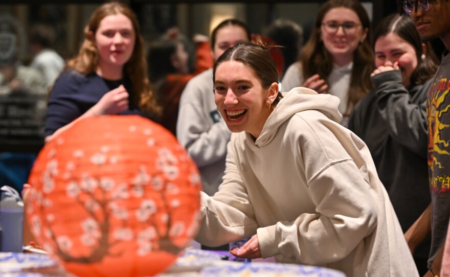 University of Scranton students react while playing a game with chopsticks during a Lunar New Year celebration.