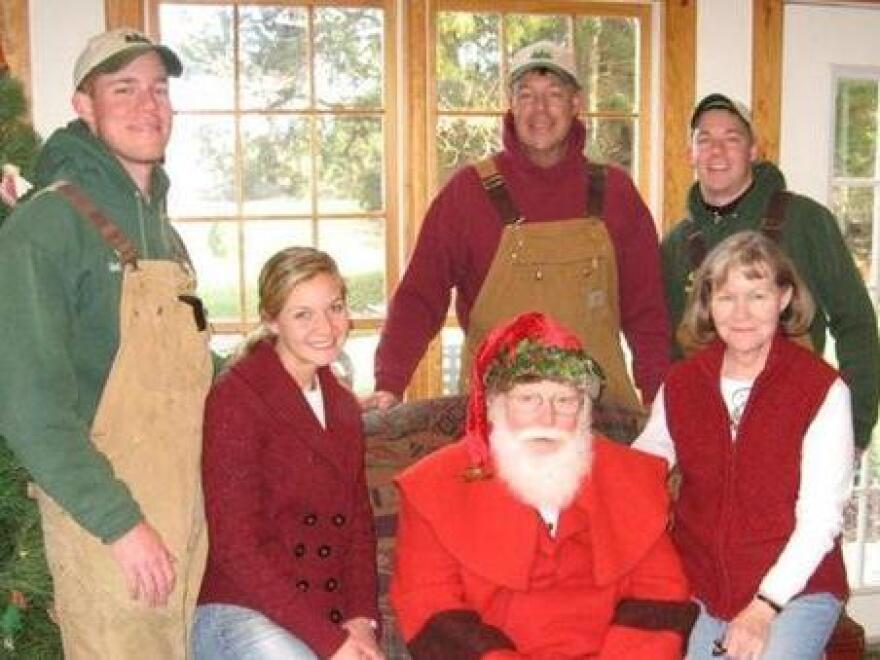 The Carroll family has turned the holiday season into their family business. The family is pictured here with Santa, who visits their Christmas tree farm on weekends in December.