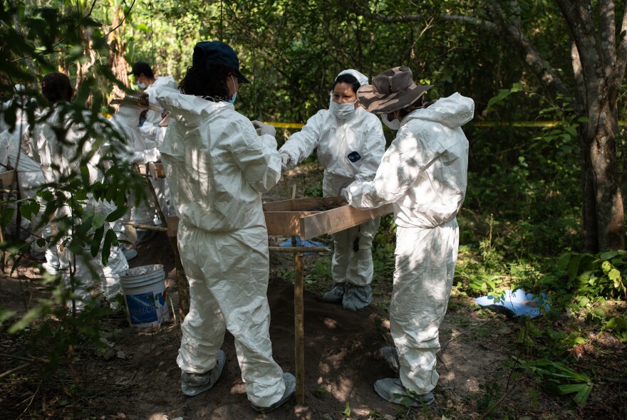 Relatives of missing persons and forensic experts work together at a location where human remains have been identified.