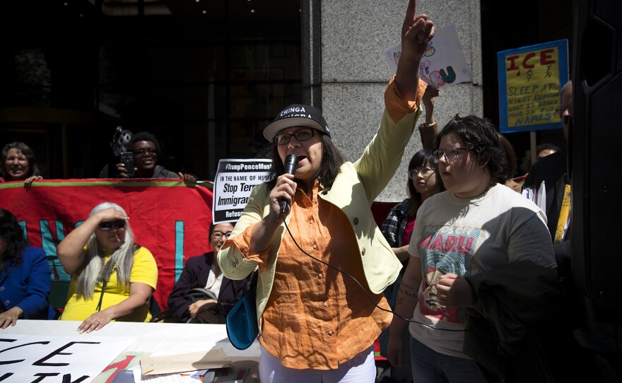 Maru Mora leads a chant, standing next to her daughter, Josefina Mora, 20, right, after an ICE hearing on Tuesday, June 26, 2018, outside of the Immigration Court building on 2nd Avenue in Seattle. 