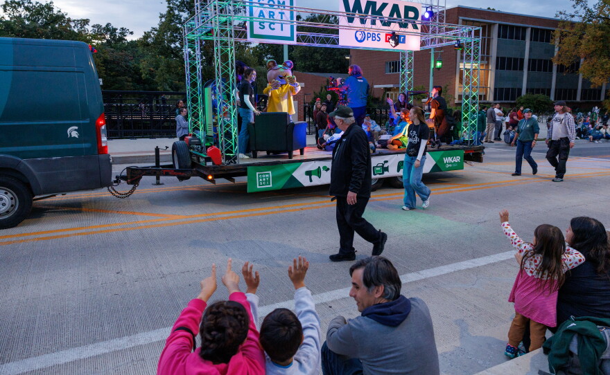 Excited attendees of the Michigan State University Homecoming Parade react to PBS KIDS character Arthur riding on the WKAR float in East Lansing, Mich., on Oct. 9, 2026.