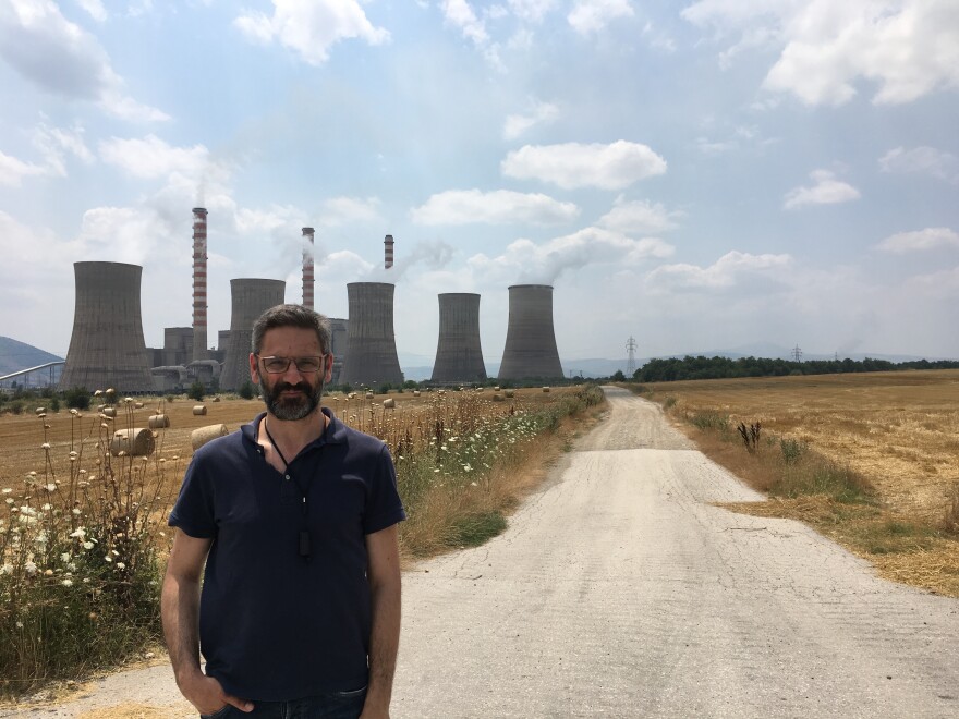 Kozani Mayor Lefteris Ioannidis stands in front of the Agios Dimitrios coal plant, one of the most polluting in Europe. A longtime environmentalists, he's trying to convince the Greek government to retrain coal workers for jobs in the renewable industry, like assembling wind turbines or solar panels.