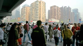 A busy street scene shows a crowd of people rushing to work in central Beijing, April 19, 2007. Beijing's local government is among the three dozen beginning to collect data to rate creditworthiness. (Teh Eng Koon/AFP/Getty Images)