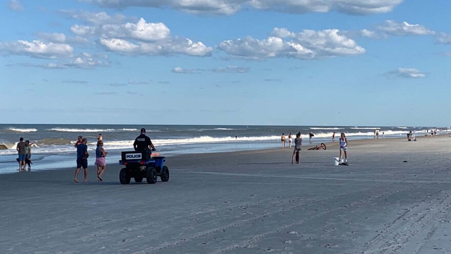 police officer riding on ATV on the sand