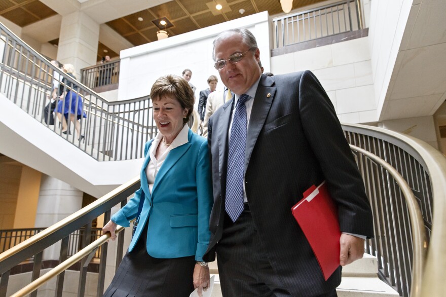 Sen. Mark Pryor, D-Ark., walks with Sen. Susan Collins, R-Maine, on Capitol Hill on June 4.