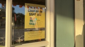 A sign welcoming SNAP customers hangs in a window.