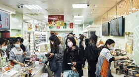 Customers wear face masks inside a store on Dec. 2, 2020, in Taipei, Taiwan. Taiwan imposed mandatory mask-wearing regulations in some circumstances, including on transport services and in markets and restaurants, as it tries to keep its record of controlling COVID-19 infections in check. (An Rong Xu/Getty Images)