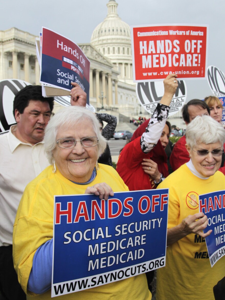 Protesters, joined by members of Congress, voiced their opposition to any cuts in Medicare, Medicaid and Social Security benefits on Oct. 26 in Washington.