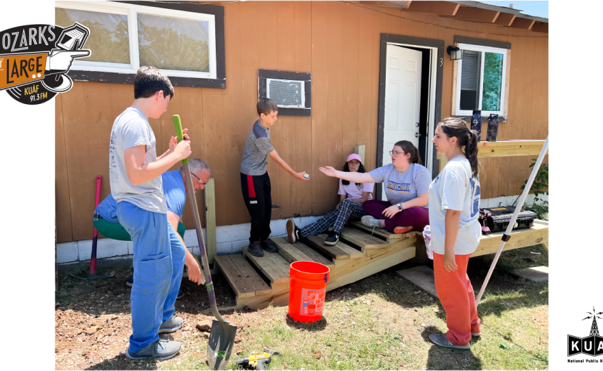 A group of students working on a set of stairs in Fayetteville.