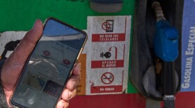 Retiree Jorge Reyes shows his phone with the app "El Ticket" which is used to reserve a place in line to buy rationed gasoline in Havana, Cuba, Monday, Feb. 16, 2026.