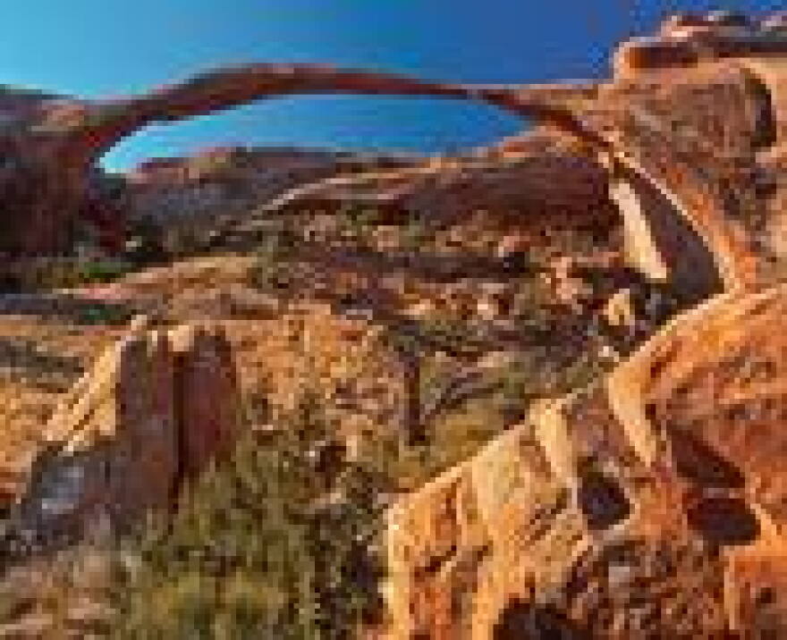Landscape Arch, the longest span in Arches National Park. In 1991, visitors videotaped a boxcar-sized slab crashing from its roof.