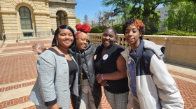 Chicago high schoolers Elayja Stewart (far left), Shekinah Jackson (second from right) and Dasia Madden (far right) with their counselor Nora-Lisa Malloy (second from left) outside the Illinois State Capitol on a field trip with the school-based mental health program Working on Womanhood. (Photo courtesy of Youth Guidance)
