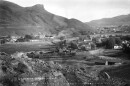 A black and white historic photo of a small town near the foothills.