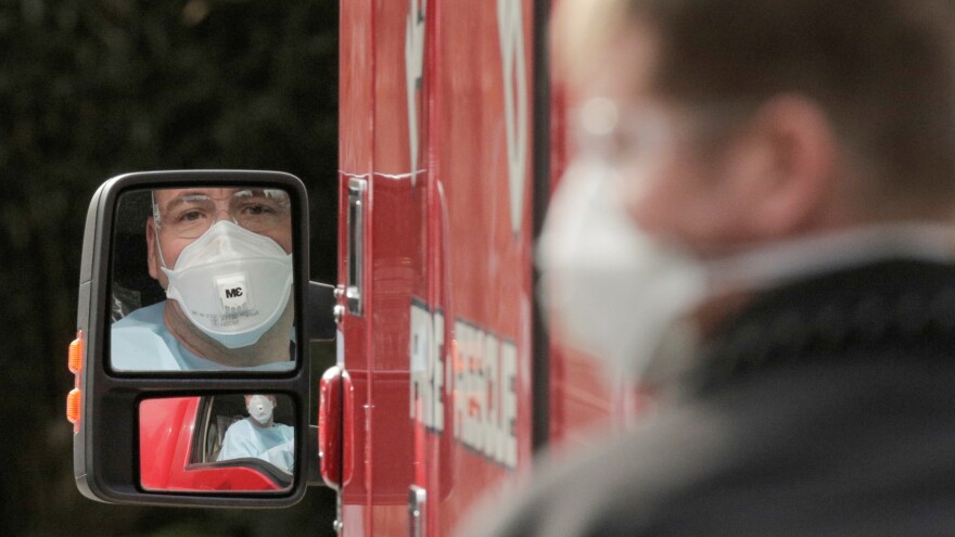 A medic drives an ambulance at the Life Care Center of Kirkland, Wash., which has been linked to most of the deaths in the U.S. from the coronavirus disease COVID-19 so far.