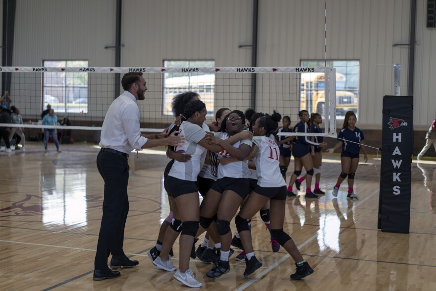 The junior varsity girls' volleyball team celebrates winning a game against Clyde C. Miller Academy Wednesday.