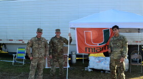 National Guard members at this point of distribution are ready to load ice into the cars of hurricane victims. 