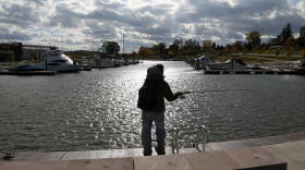 Mike Arena casts a line into the Port of Rochester harbor, where Gov. Andrew Cuomo announced $43 million for Monroe County and $41 million for Wayne County in Lake Ontario Resiliency and Economic Development Initiative. Credit Max Schulte / WXXI News