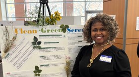  Gweny Love poses in front of a display.