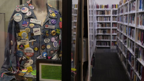 A pin display anchors a section of the Stonewall Museum Library