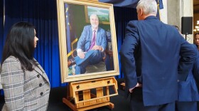 Gov. Eric Holcomb and First Lady Janet Holcomb view the newest gubernatorial portrait, painted by artist Russell Recchion, on Friday, Dec. 13, 2024, following an unveiling ceremony at the Indiana Statehouse.