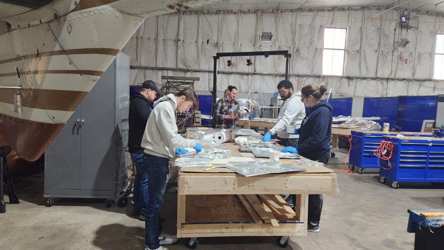 Students in Johnson College's aviation technology program work with