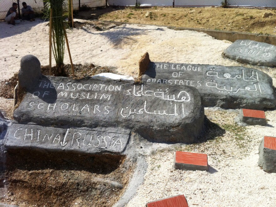 <p>At the Altinozu camp in southeastern Turkey, the Syrian residents have built a mock graveyard. A freshly dug "grave" is for China and Russia, which vetoed a recent U.N. resolution against Syria. Other headstones are for the Arab League and the Association of Muslim Scholars, which have also disappointed the Syrian opposition.</p>