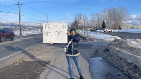 Lisa Meisner holds a sign in the Dark Skies petition drive Jan. 24.