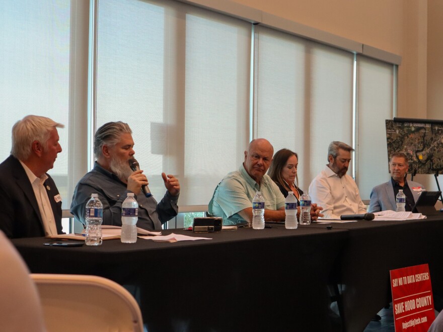 A panel including local leaders and candidates, such asSomervell County Commissioner Chip Joslin, addresses the public regarding the need for temporary moratoriums on large-scale developments.