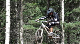 In an Aug. 21, 2010, photo, Andy Nagle of Albuquerque, N.M., rides a jump line at the bike park in Angel Fire, N.M.