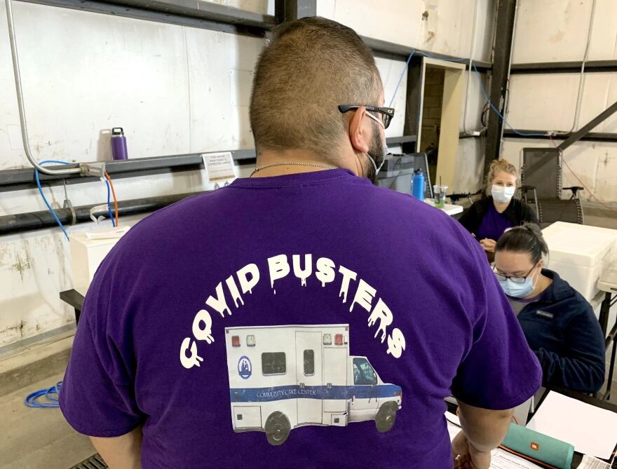 Klamath Health Partnership Clinical Information Specialist Diego Aguirre shows off the organization&#39;s mobile COVID testing shirt.