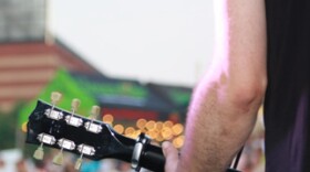 A close-up of a guitar player.