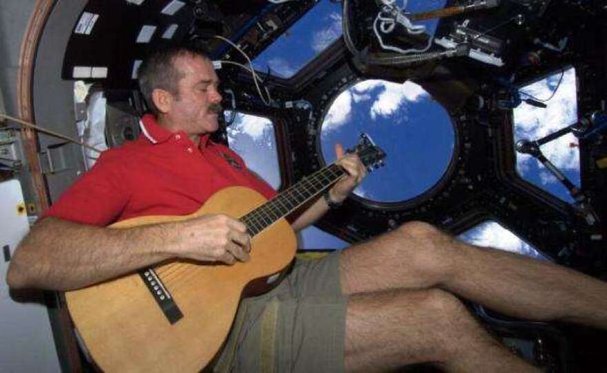 To pass the time, Canadian Astronaut Chris Hadfield plays guitar. His music videos made quite the splash on social media. Photo: NASA