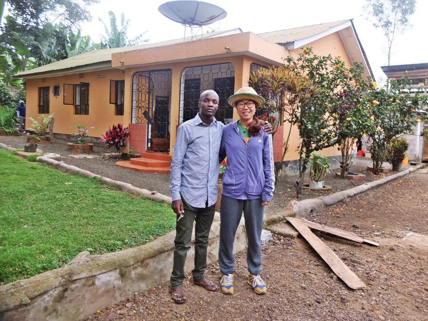 Godwin Ndosi rents out rooms at his parents' house to guests around the world through websites like Airbnb. He's standing with one of his international visitors.