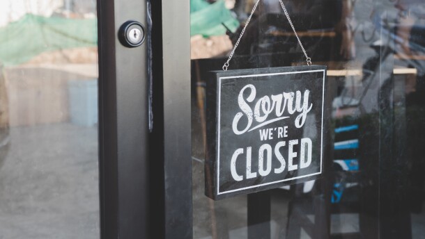 "We're closed" sign on the door of a business. Stock Photo