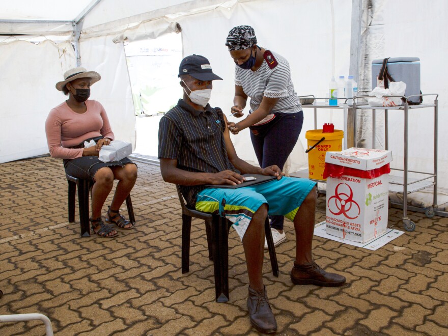 A man receives a dose of a COVID-19 vaccine in Soweto, South Africa. The omicron variant of the coronavirus, first identified in South Africa, has now spread to at least a dozen other countries. On Friday, scientists presented evidence that the variant spreads twice as fast as the delta variant.