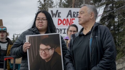Linda Rexford holds a photo of her brother, William Rexford, while standing beside their father, Herman Rexford, at a protest in Fairbanks on April 11, 2026. William Rexford was shot and killed by Alaska State Troopers while experiencing a mental health crisis on Jan. 1, 2026.