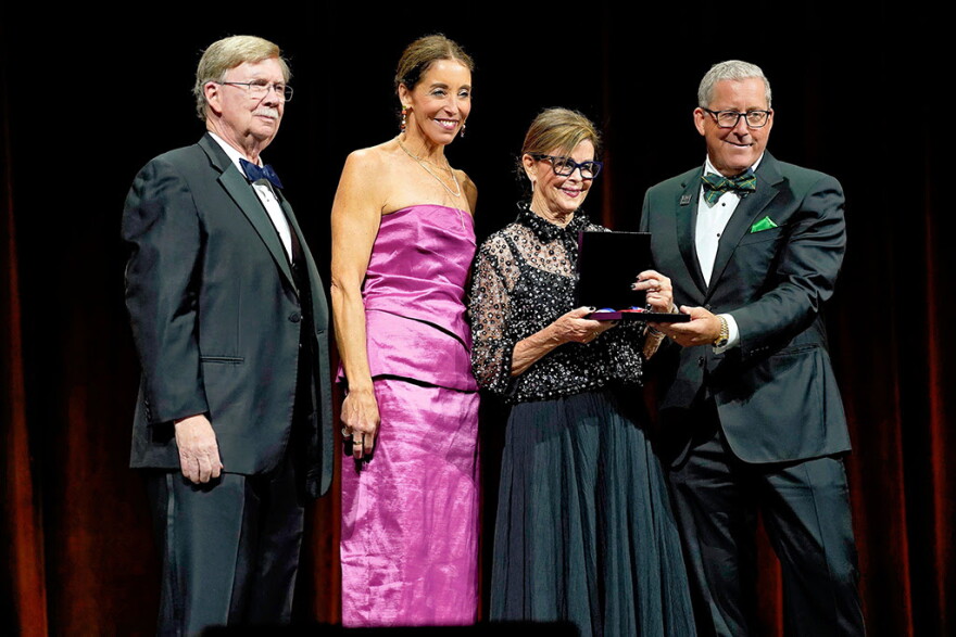 From left to right: Retired Maj. Gen. John L. Barry presents John D. Odegard's National Aviation Hall of Fame award to members of Odegard's family; daughter Stephanie Odegard LaDue, wife Diane Odegard and son John Odegard Jr.