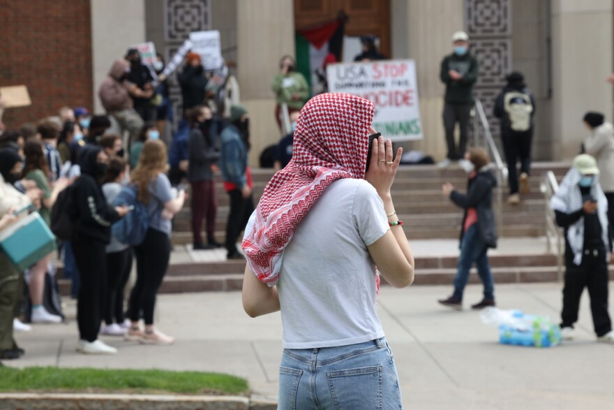 Protesters gather outside and on the steps of Wallis Hall on Wednesday, May 1, 2024, where some have begun a sit-in inside