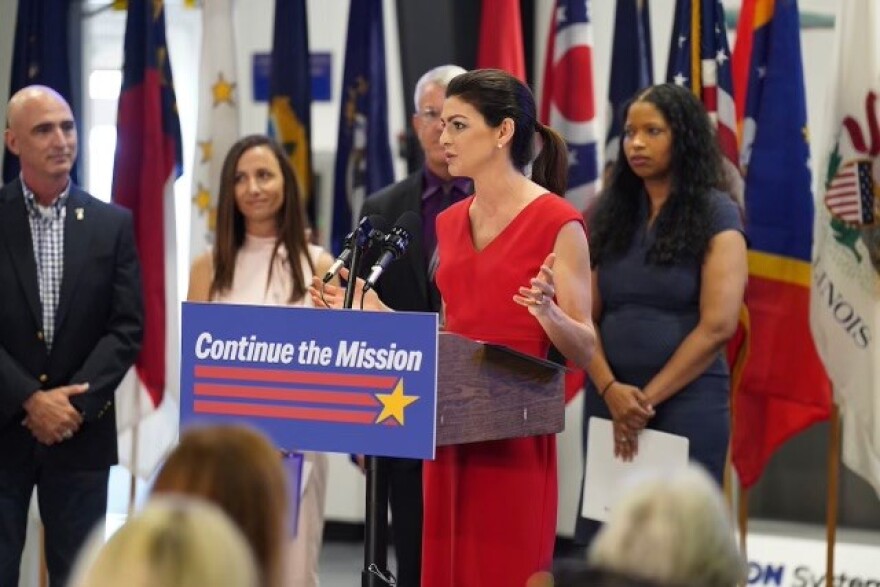 Casey DeSantis speaks at the podium announcing the initiative.