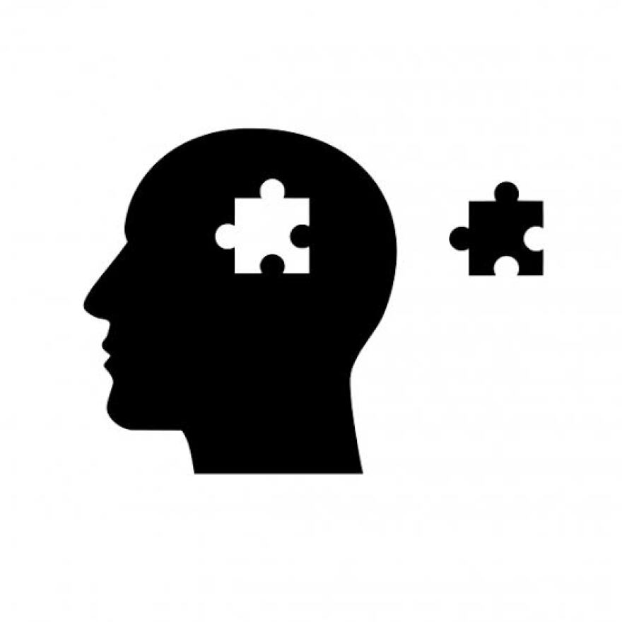 Picture of a head silhouette with a missing puzzle piece, representing mental health awareness.