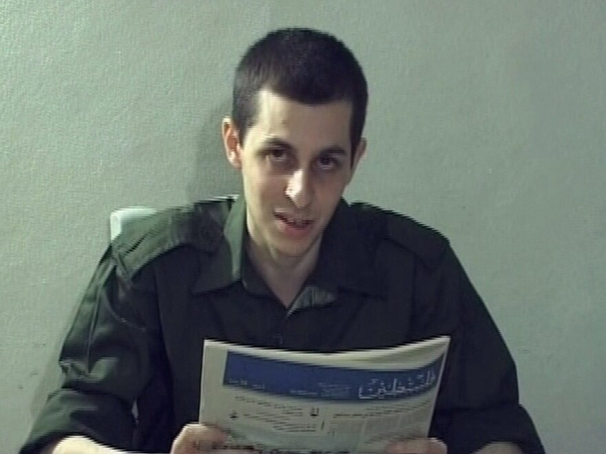<p>In this video grab released on Oct. 2, 2009, captured Israeli soldier Gilad Shalit is seen holding a Palestinian newspaper. Shalit, who has been held by Palestinians for more than five years, is set to be released Tuesday.</p>