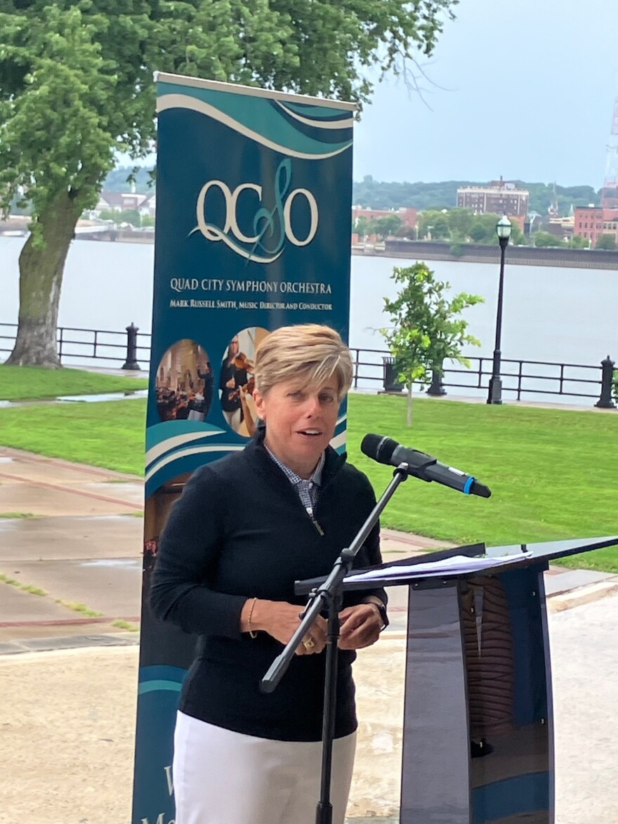 Bank president/CEO Laura "Divot" Ekizian speaks about the extended Riverfront Pops sponsorship at a press conference Aug. 5, 2026 at LeClaire Park, Davenport.