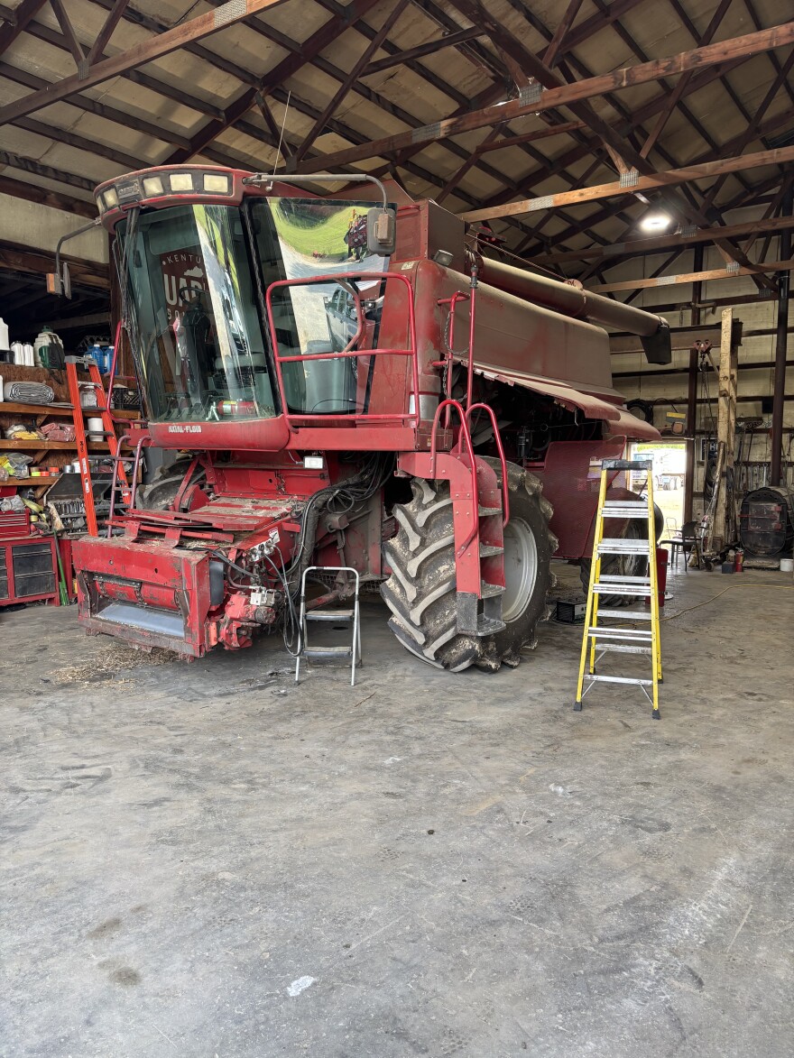 A large, red  2003 combine sits in a repair shop on Edwards farms in Paducah, Kentucky. 