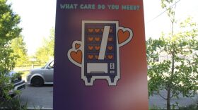 A cardboard sign promoting a new reproductive health vending machine project rests against a post outside Skeeta Hawk Brewery on Saturday, April 12, 2025.
