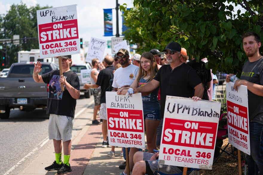 Striking UPM Blandin paper mill workers and supporters wave to honking vehicles on Highway 2 during a rally led by Teamsters Local No. 346 leadership Friday, July 21, 2023, in Grand Rapids, Minnesota.