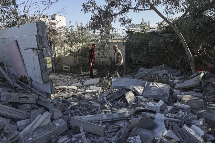 Palestinians search for their belongings amid the rubble of houses destroyed by an Israeli bombardment in Rafah in the southern Gaza Strip on March 11.