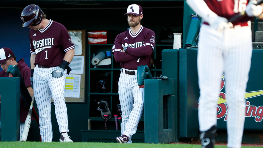 Head Coach Joey Hawkins watching over the team from the dugout last season, 2026