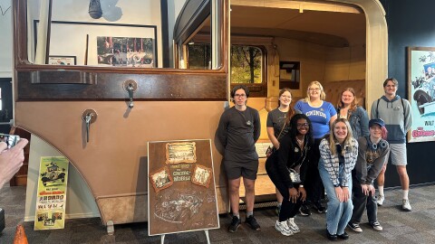 Students in the "Walt's Pilgrimage" course at WMU pose in front of a set-piece from the 1967 Disney film, The Gnome-Mobile, at the Gilmore Car Museum in Barry County. The group will embark on a nine-day journey this summer, visiting Disney-related sites in Illinois, Missouri and California.