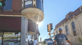 Dominic Vittone of Janesville holds a sign decrying Republican cuts to health care on the sidewalk outside the Rock County Democrats’ office in downtown Janesville from September of this year. Early voter data suggests southern Wisconsin could be a battleground area in deciding many races in the state. Midterm Election day is Tuesday, November 3.